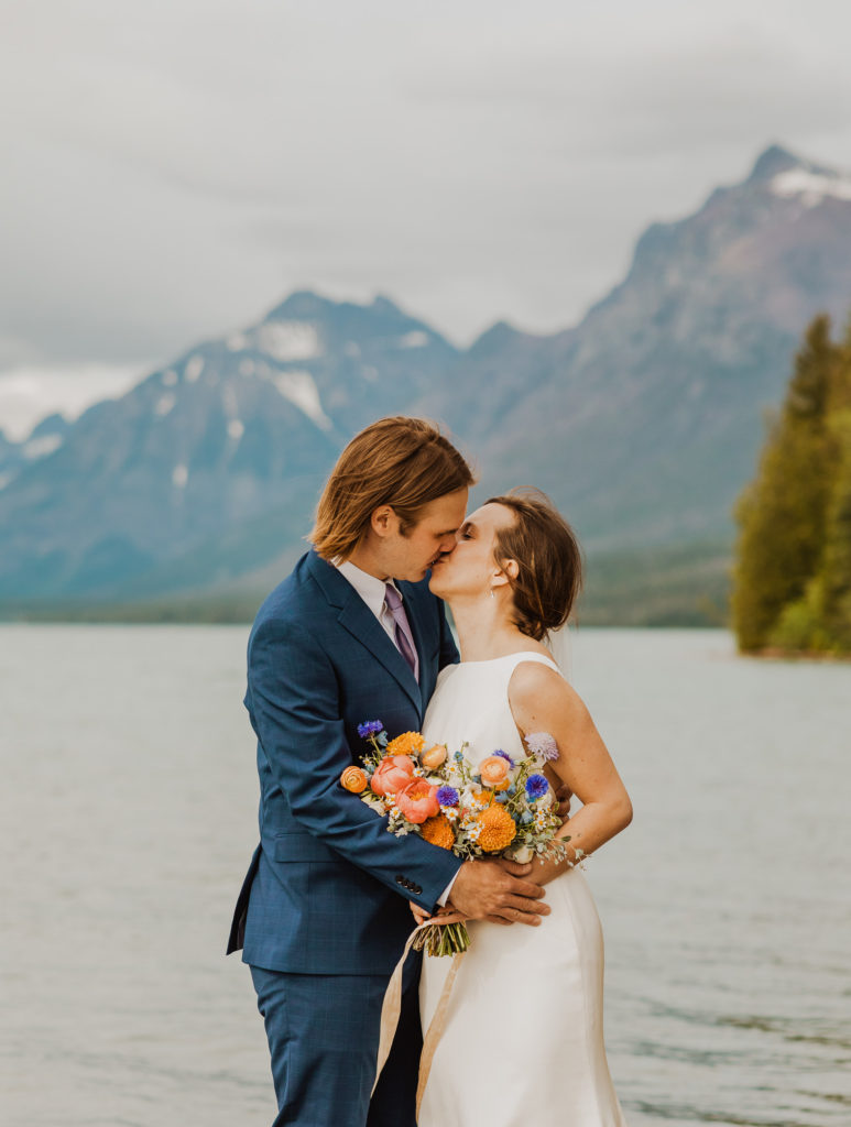 Bride and groom kissing Lake McDonald Elopement