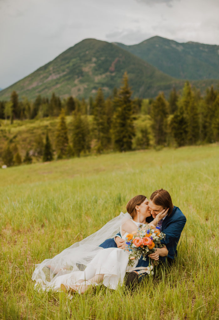 Bride and groom in field after Lake McDonald Elopement