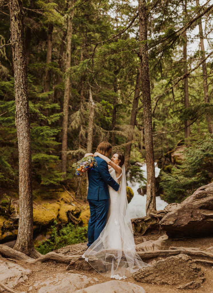 Bride and groom embracing each other in Glacier National Park after Lake McDonald Elopement