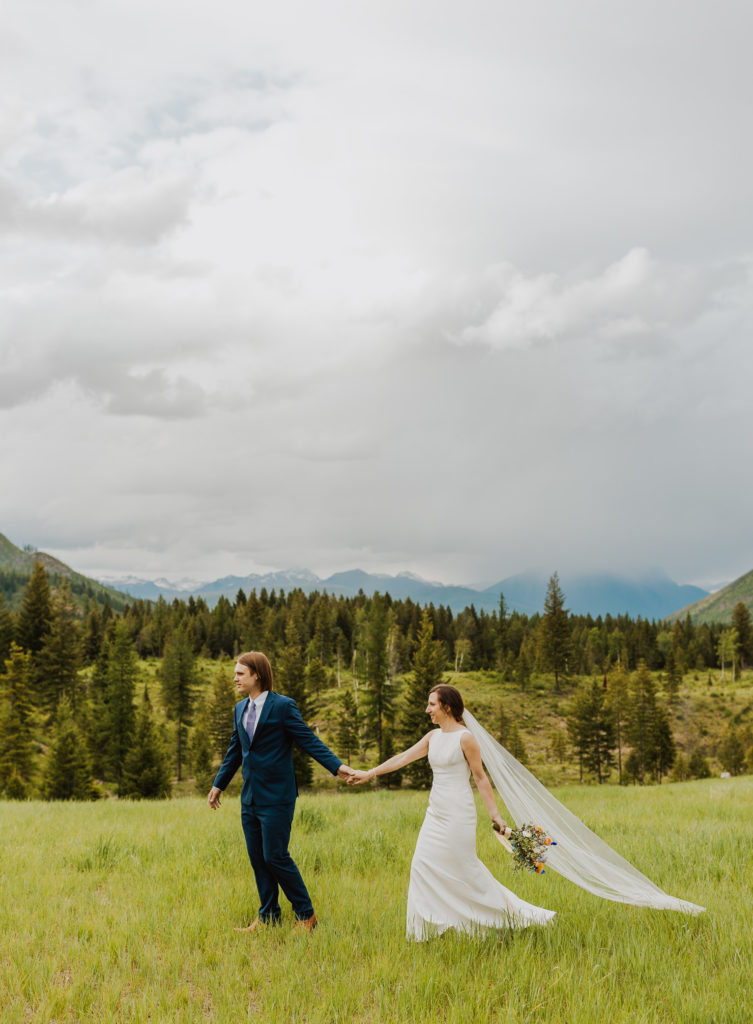 Bride and groom in a field after Glacier National Park Lake McDonald elopement.