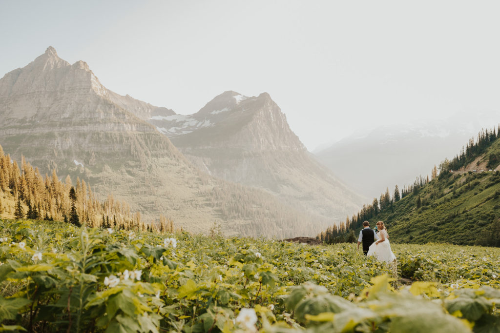 All-Inclusive Glacier National Park Elopement Ceremony Mountain View wildflower field. Bride and groom dancing