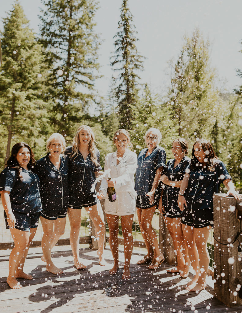 Bride with Bridesmaids and Champagne shower. Elopement Photography by Haley Jessat