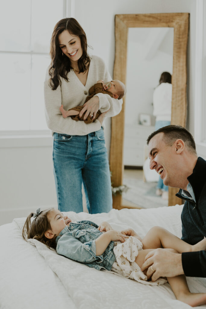 Family playing on bed. Lifestyle photography.