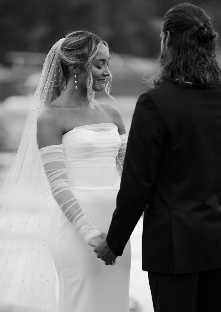 Black and white bride and groom holding hands