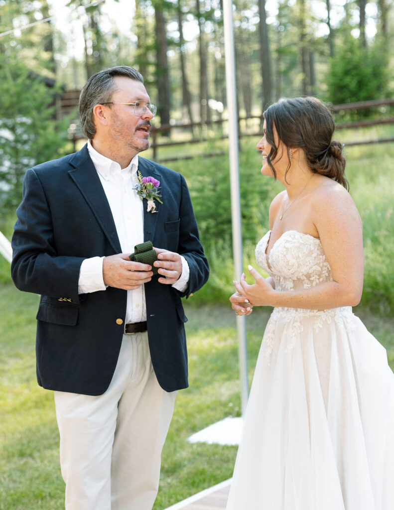 Bride chatting with a guest during the reception, both smiling and enjoying the celebration, showcasing a friendly and welcoming atmosphere at Amen Ranch.