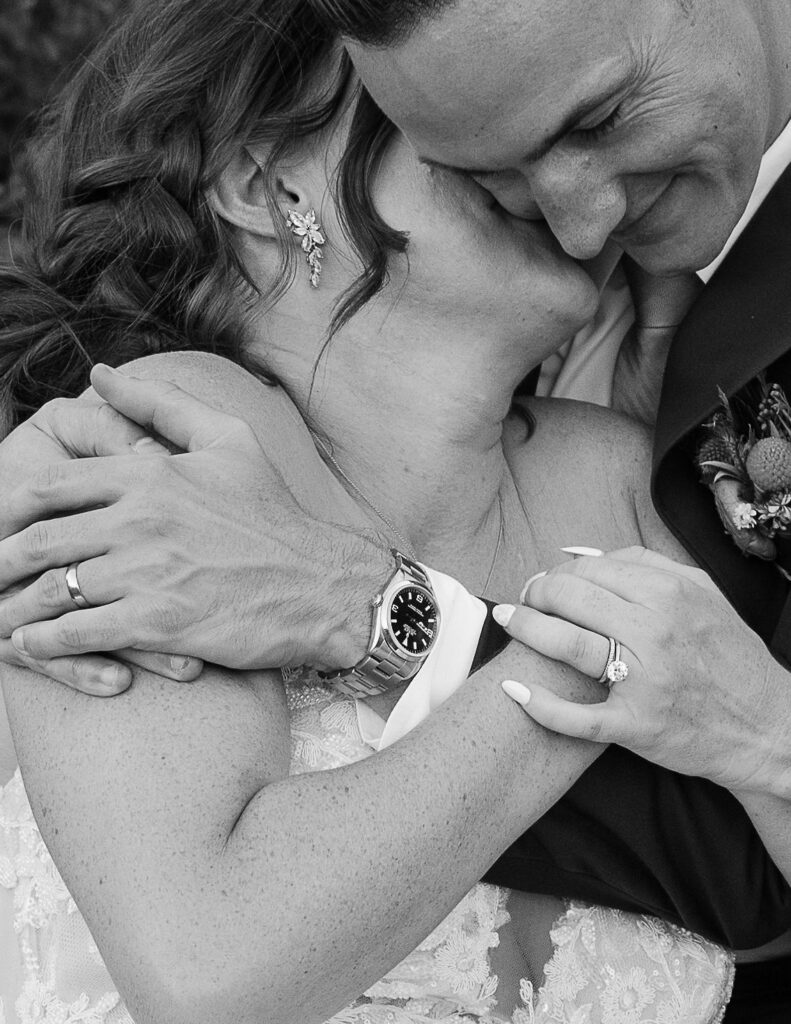 Close-up of the bride and groom embracing closely, capturing an intimate and emotional moment during their wedding at Amen Ranch in Montana.