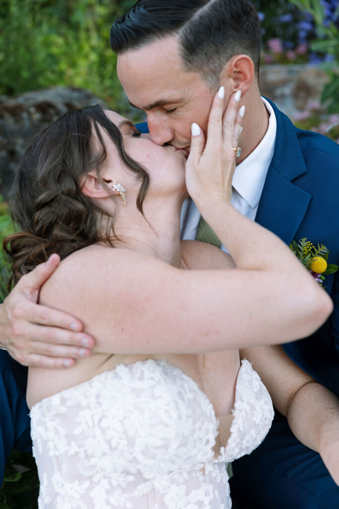 Bride and groom sharing a joyful kiss, embracing each other closely, capturing a tender and romantic moment at Amen Ranch in Montana.