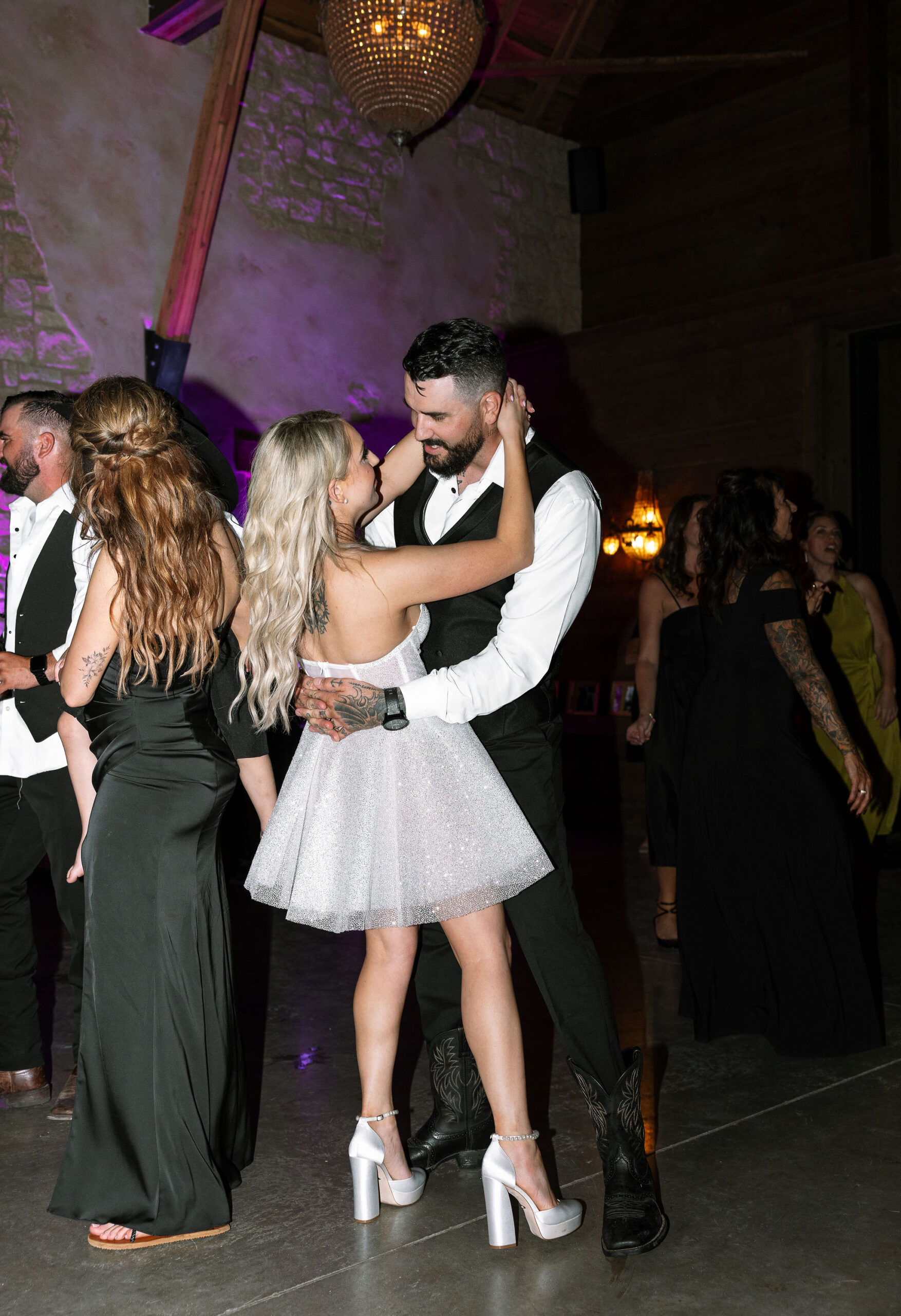 The bride and groom dancing during the reception at Copper Rose Ranch Wedding Venue, with the bride wearing a sparkly short dress. Captured by Haley J Photo, a Montana Wedding Photographer.