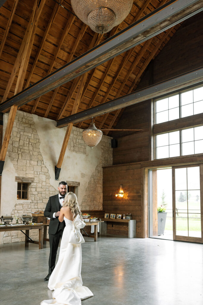 The bride and groom sharing a dance inside the barn at Copper Rose Ranch Wedding Venue, with high wooden ceilings and warm natural light. Captured by Montana Wedding Photographer Haley J Photo.