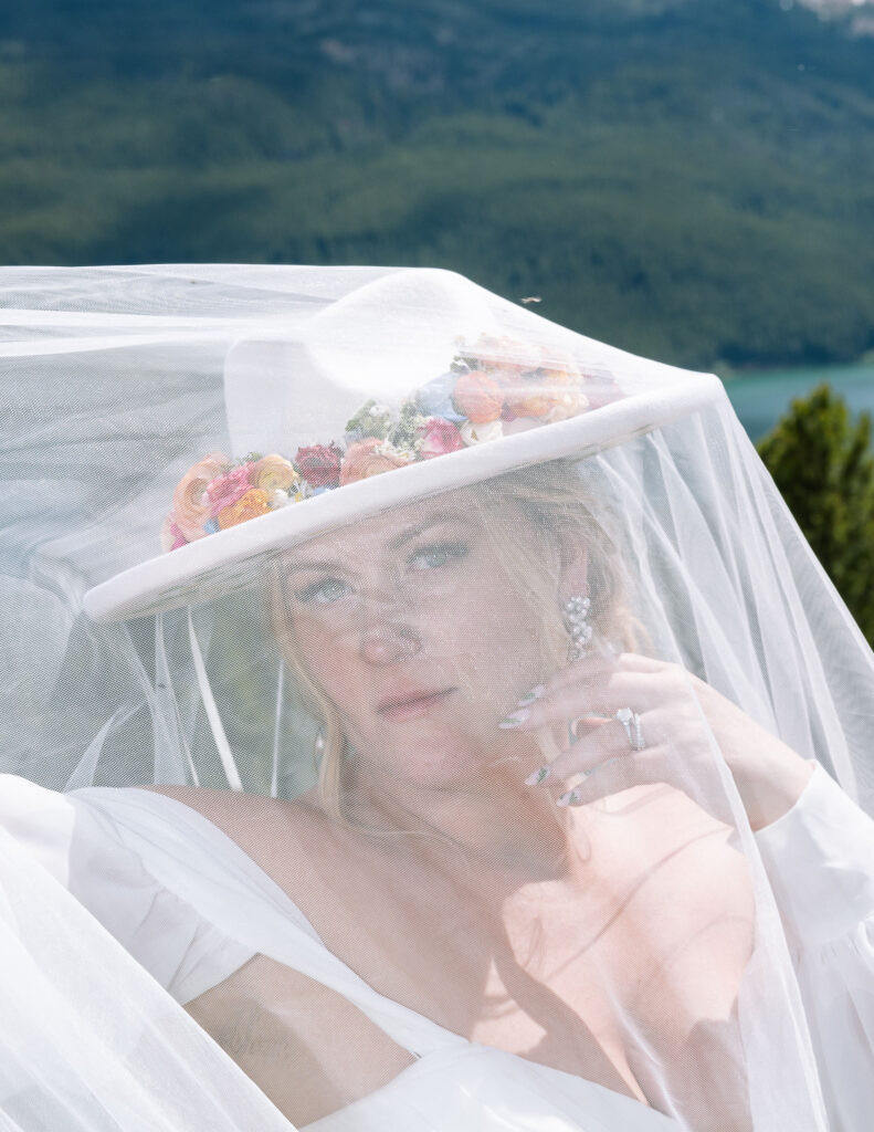 Close-up of the bride’s face, looking through her veil, with soft natural light highlighting her features.