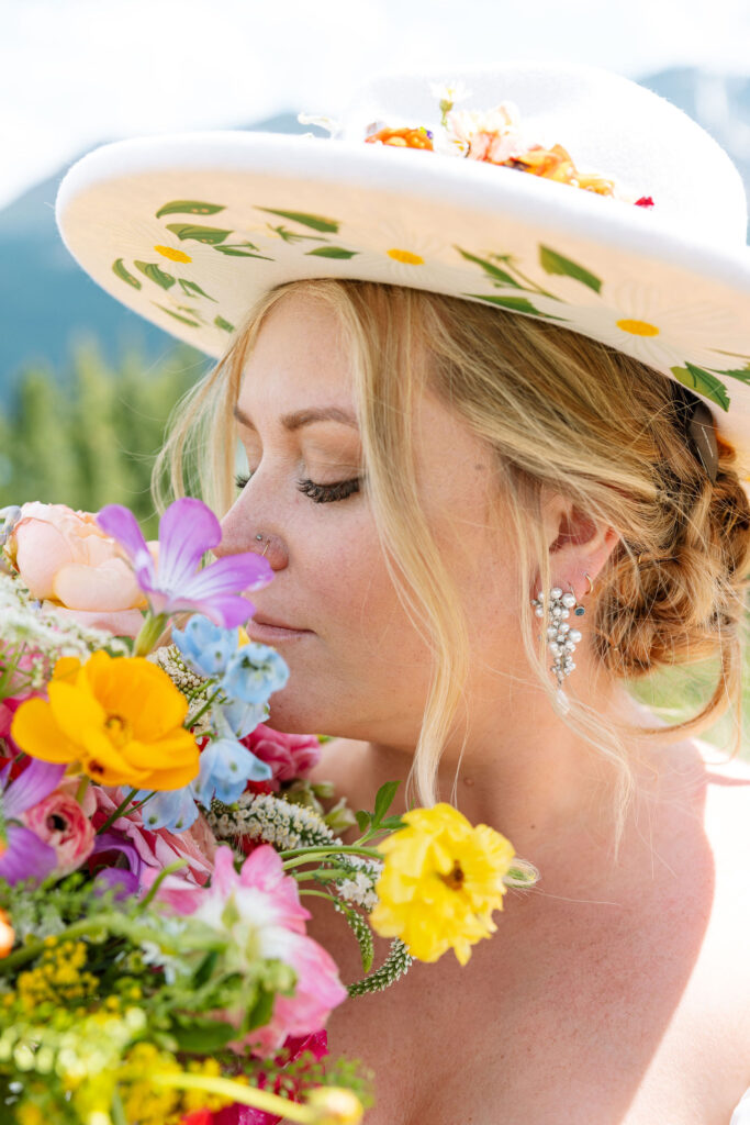 Bride smelling her bouquet, capturing a joyful moment before the ceremony.