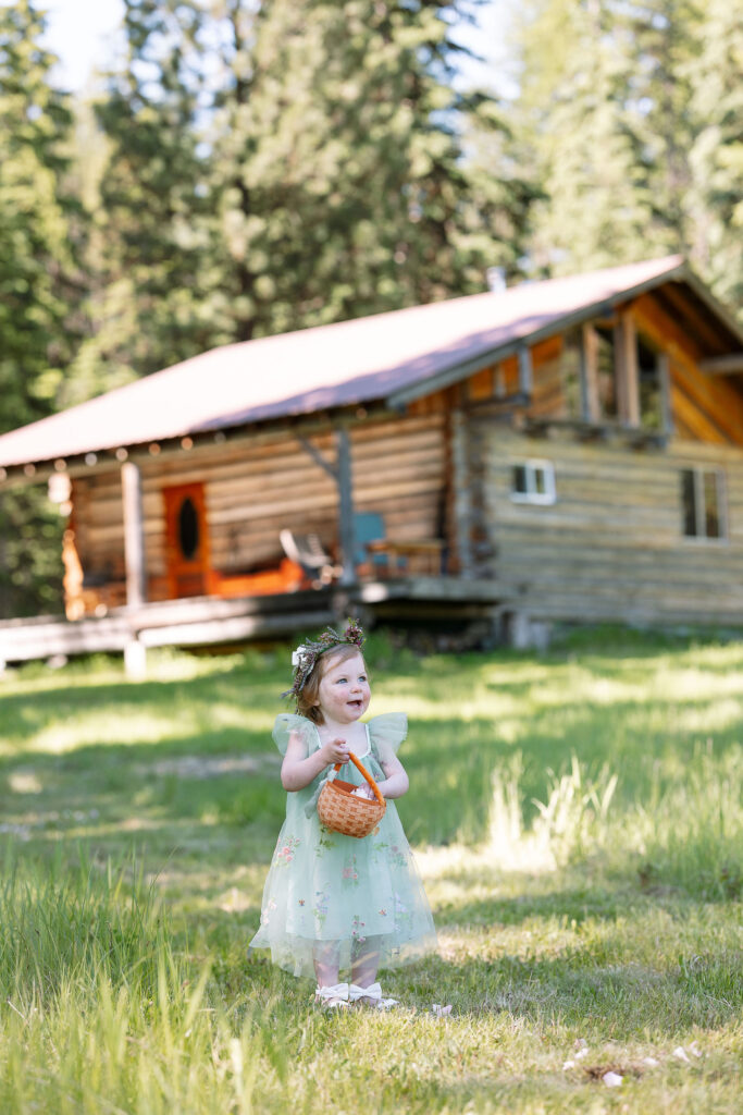 Flower girl holding a basket of flowers, smiling as she walks down the aisle.