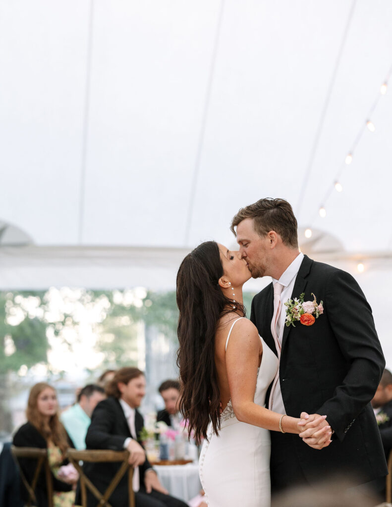 Bride and groom sharing a kiss during their first dance, shot by Haley J Photo,