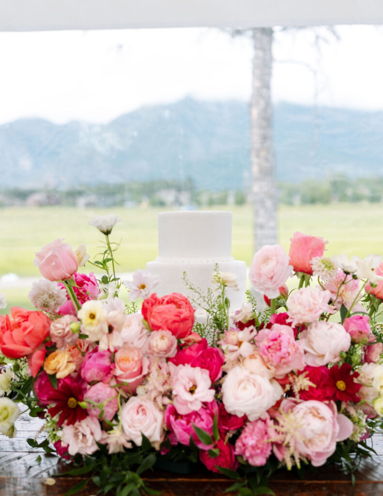 Wedding table setup with vibrant pink flowers, showcasing storytelling photography by Haley J Photo.