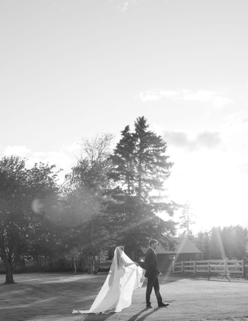 Couple standing together with a Montana mountain backdrop, captured in natural, storytelling wedding photography.