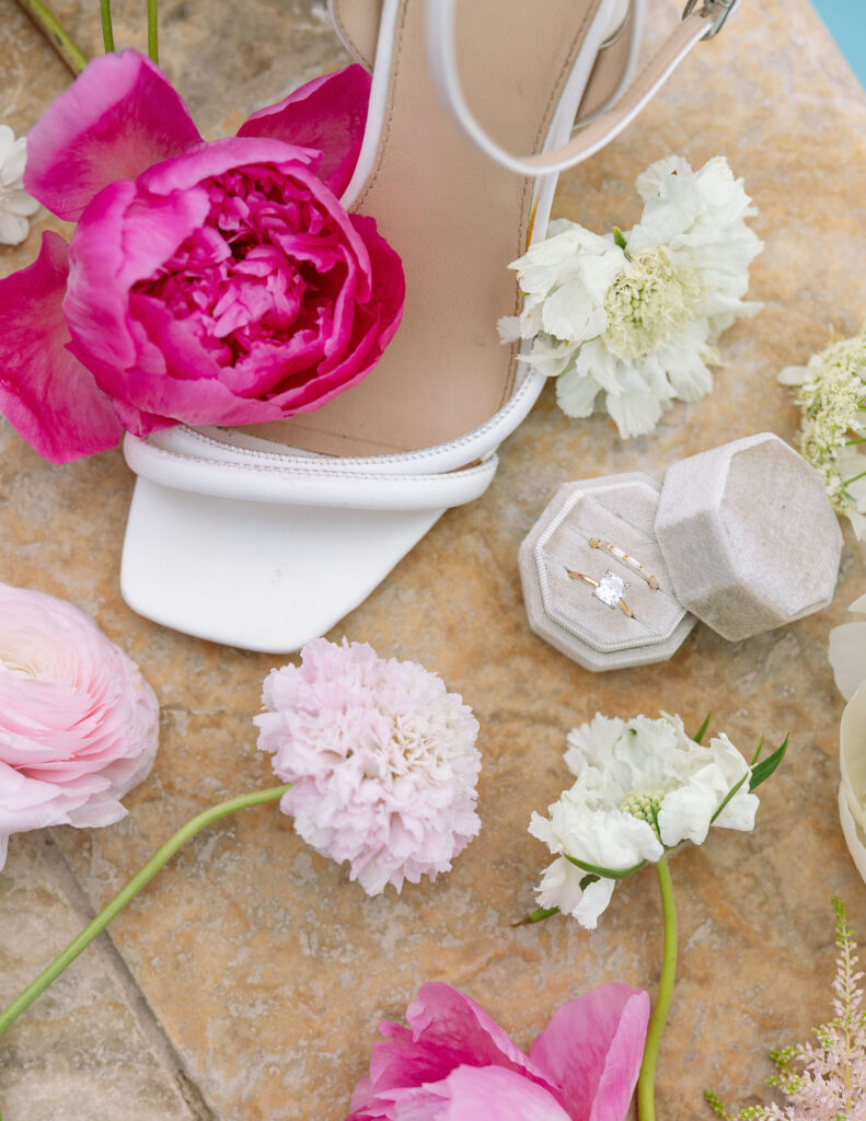 Delicate pink and white flowers, wedding rings, and wedding shoes wedding photography details by Haley J Photo