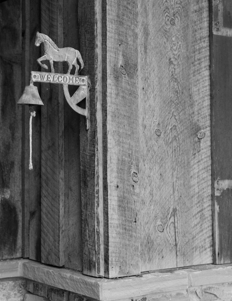 Black-and-white close-up of rustic wooden decor, part of the Montana wedding storytelling.