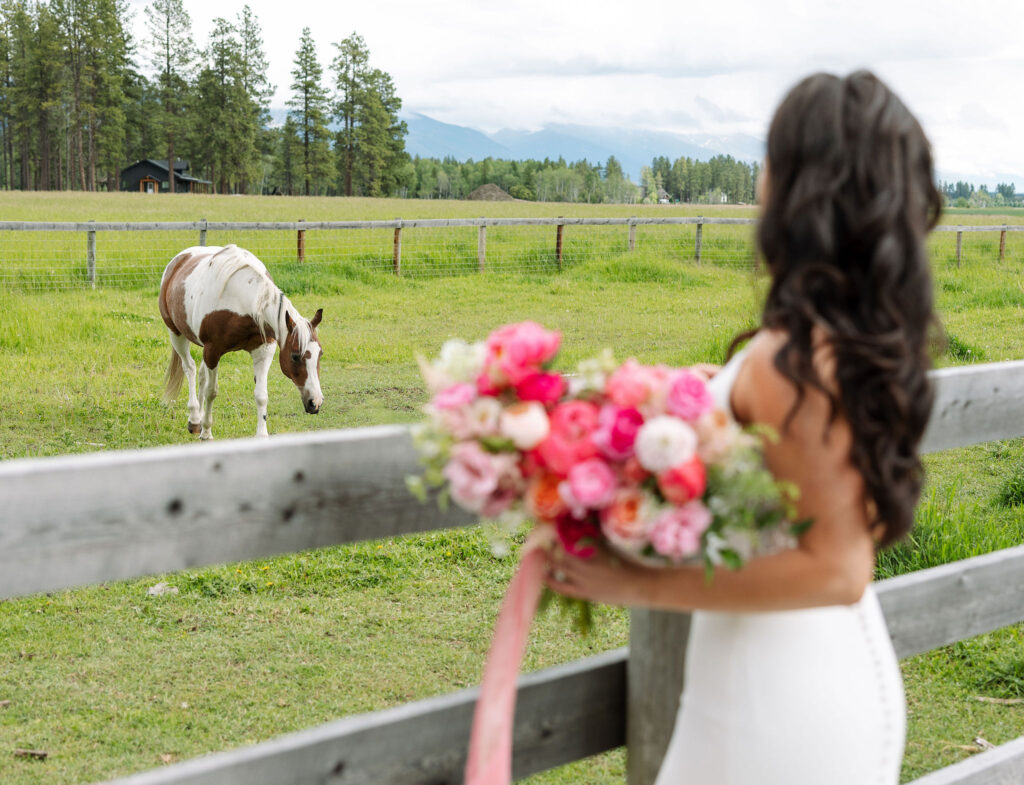 Bride holding wedding bouquet in Montana by a horse