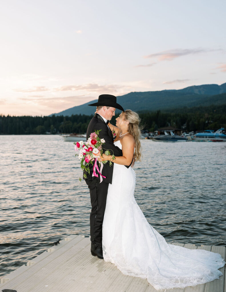 Couple share private moment beside lake after Whitefish Montana wedding