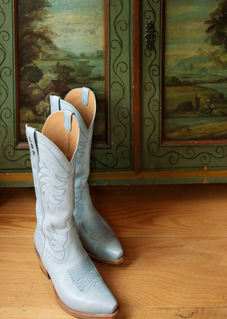 Blue Tecova boots and wedding details styled before Whitefish Montana ceremony