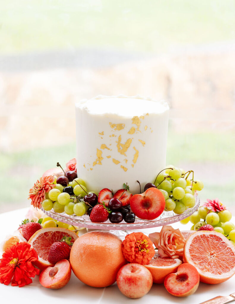 Wedding cake topped with fruit at summer Whitefish Montana wedding celebration