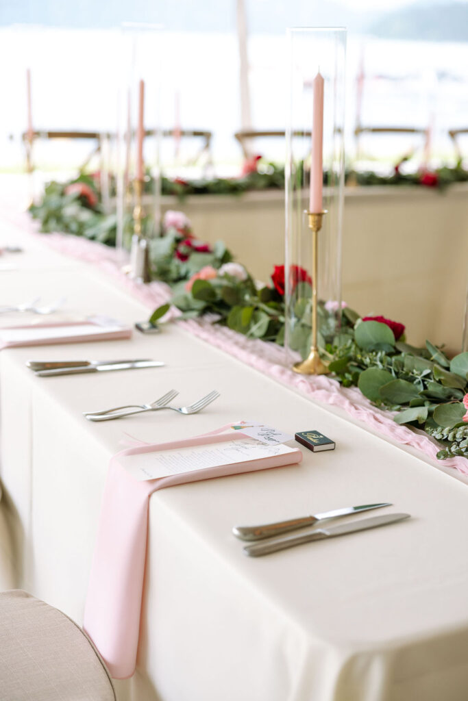 Long table set with blush pink florals at elegant Whitefish Montana wedding reception