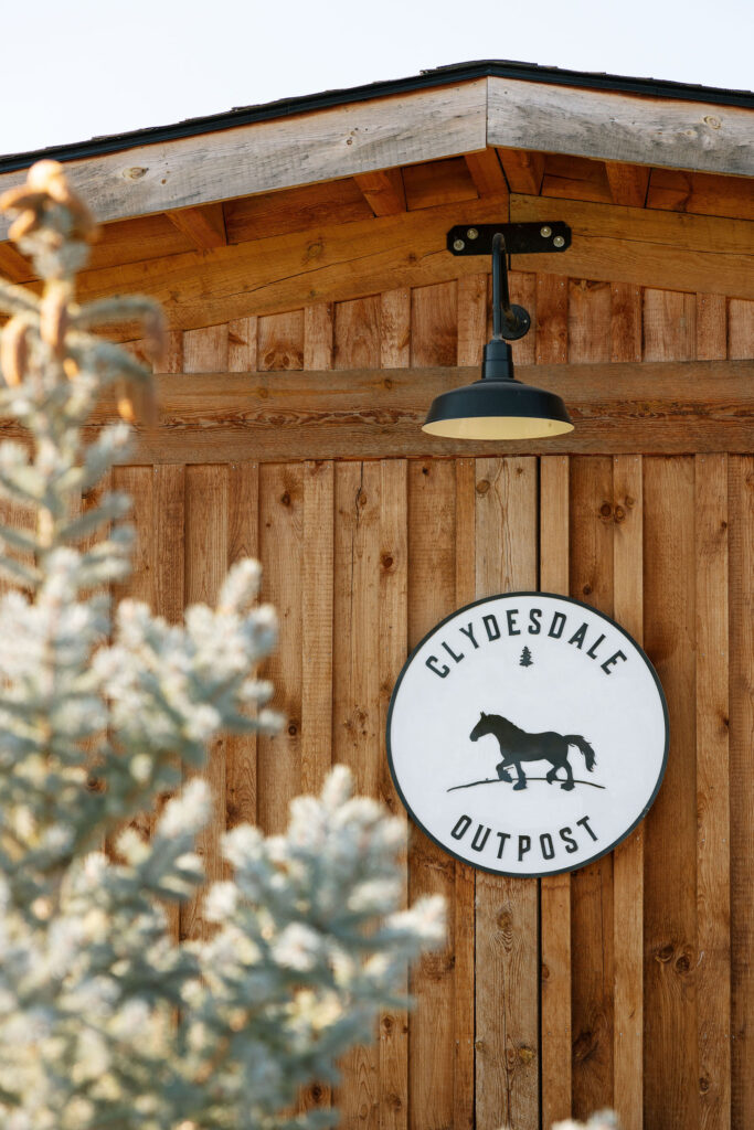 Clydesdale Outpost barn exterior with venue signage, captured on a sunny day in Whitefish, Montana.