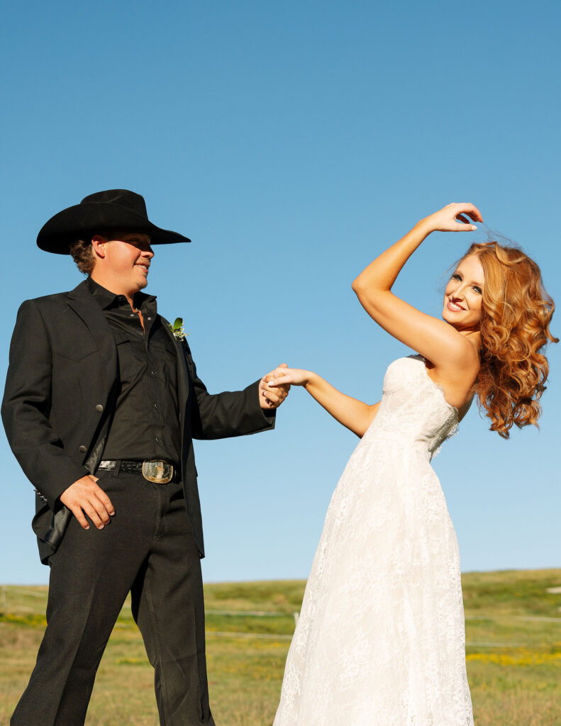 Groom lifting the bride playfully during their Clydesdale Outpost elopement, showcasing a joyful Western-inspired love story.