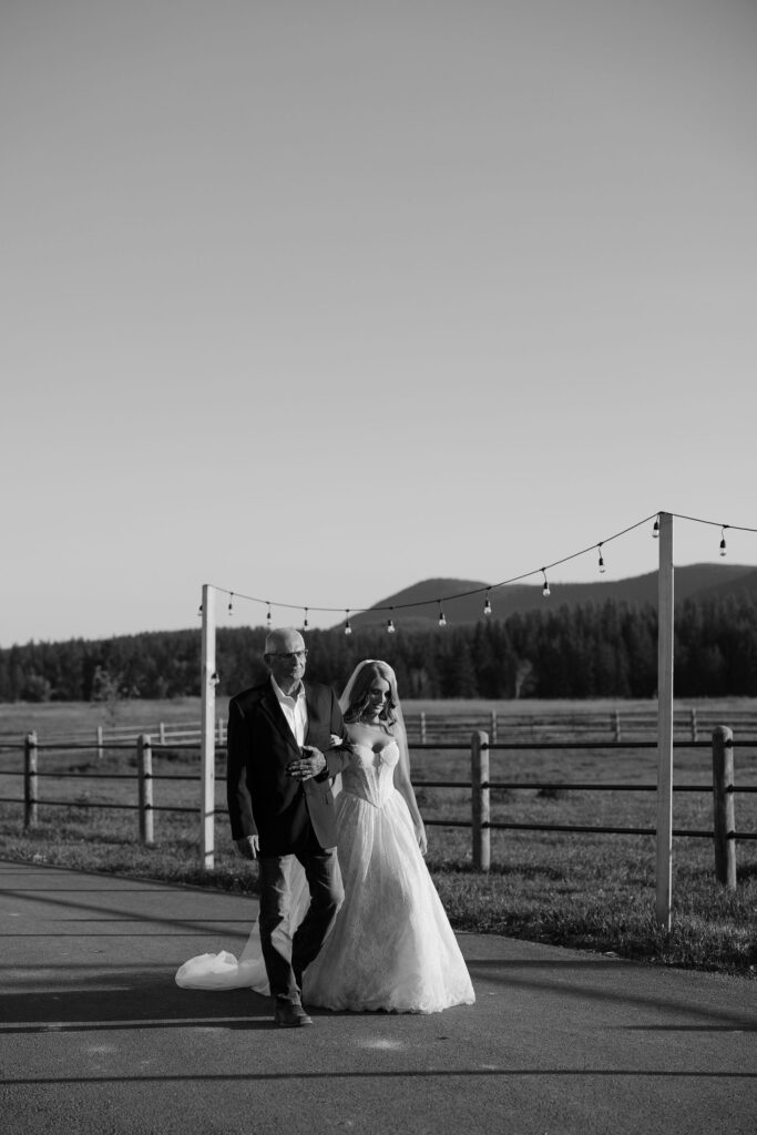 Bride walking with father down the isle during Montana Elopement.