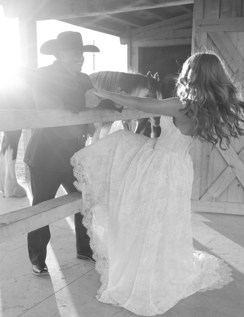 Bride laughing as her groom twirls her around during their Western-inspired elopement at Clydesdale Outpost in Montana.