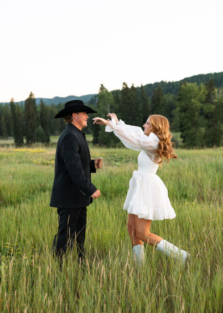 Bride and groom dancing in an open Montana field at Clydesdale Outpost, blending rustic charm with romantic Western style.