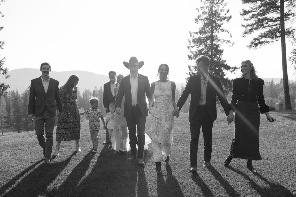 Bridal party walking together at sunset in silhouette