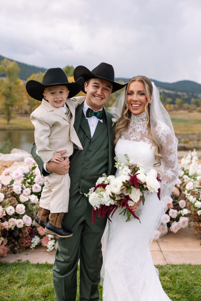 Bride and groom portrait with child during Montana ranch wedding at The Meadows on Rock Creek