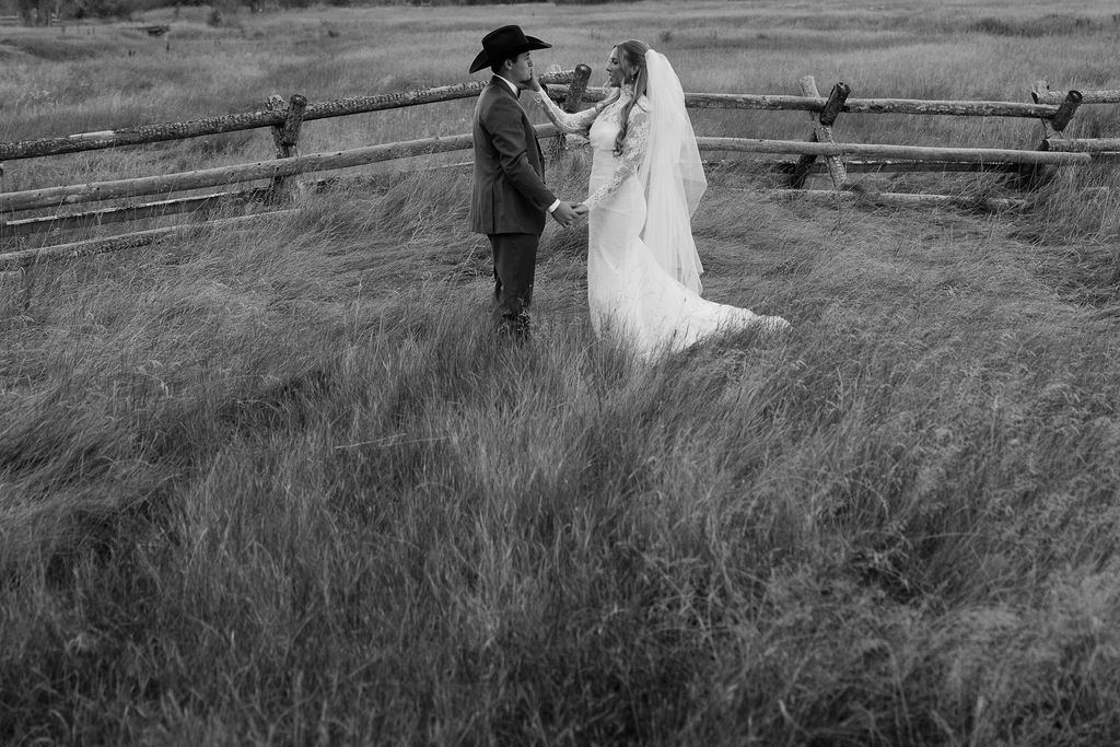 Bride and groom portrait in black and white meadow scene at Montana wedding venue