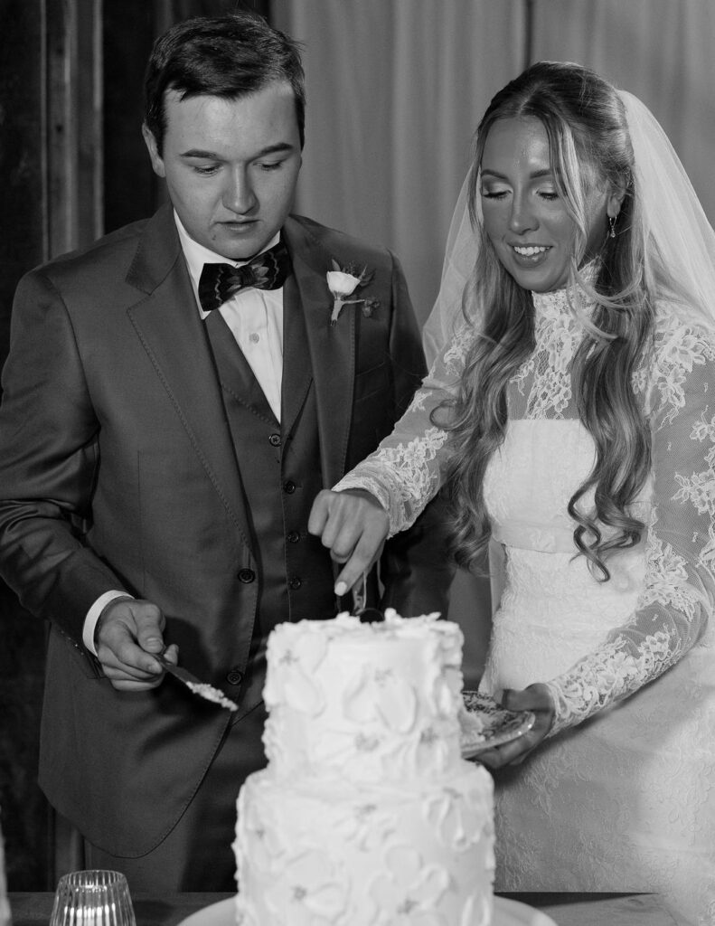 Bride and groom cutting cake at The Meadows on Rock Creek wedding photographed by Haley J Photo
