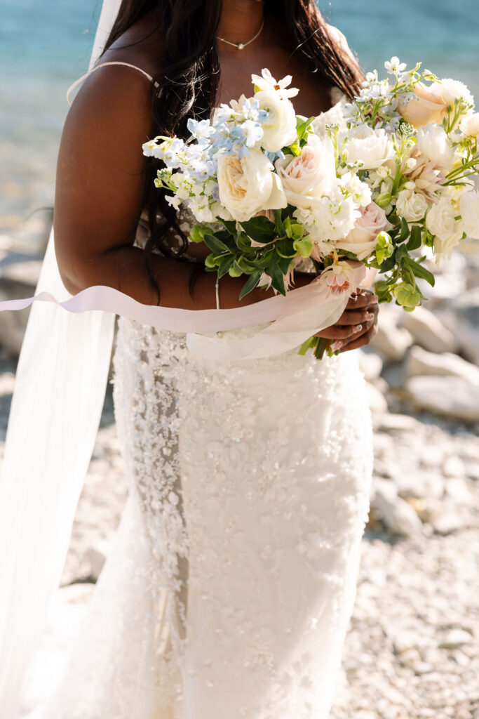 Bride and groom standing with officiant during lakeside ceremony at Glacier National Park fall elopement