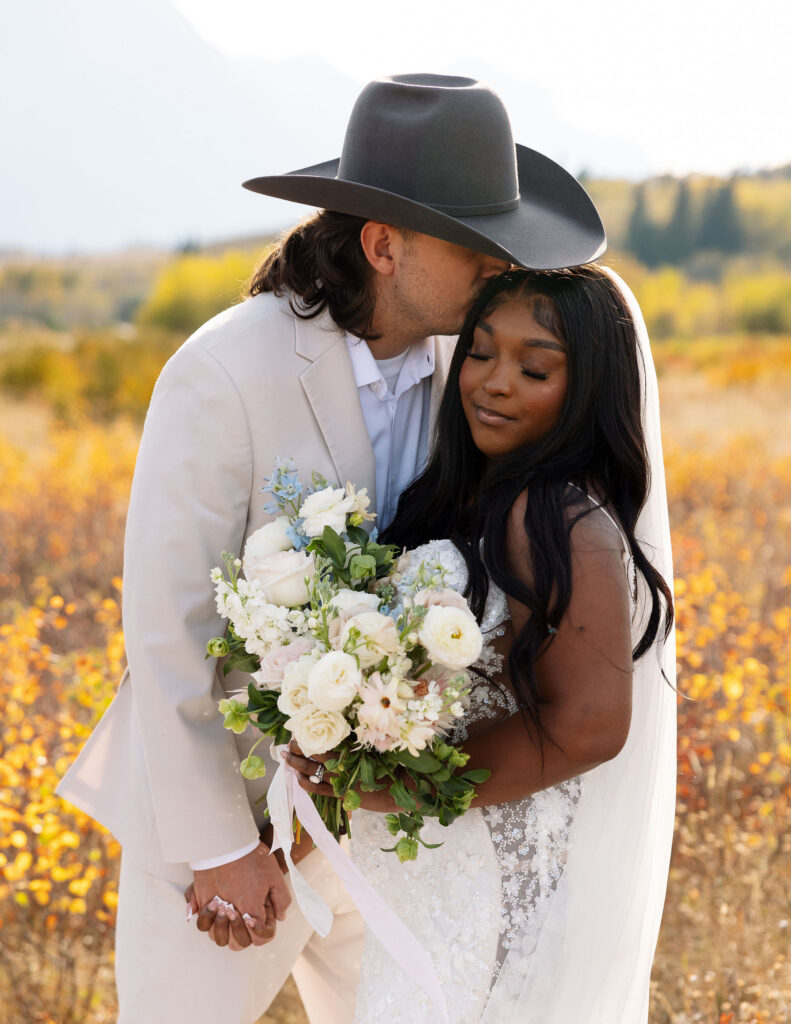 Close portrait of bride and groom holding bouquet during fall elopement in Glacier National Park