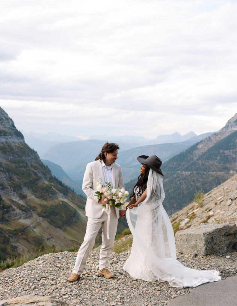 Couple standing on a mountain overlook during a fall elopement in Glacier National Park