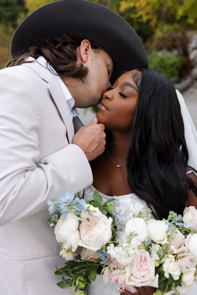 Close portrait of bride and groom embracing during intimate Glacier National Park fall elopement