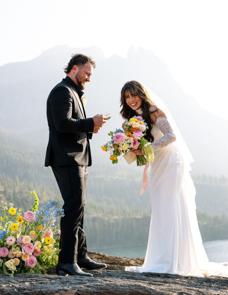 Bride and groom smiling together during their lakeside ceremony in Glacier National Park