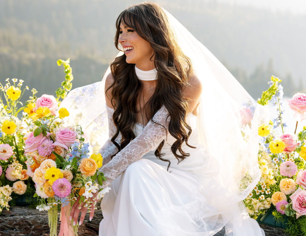 Bride smiling while holding a vibrant bouquet during her Glacier National Park elopement portrait