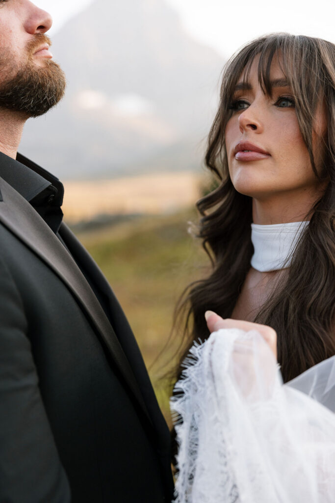 Close portrait of bride adjusting her dress during a Glacier National Park elopement
