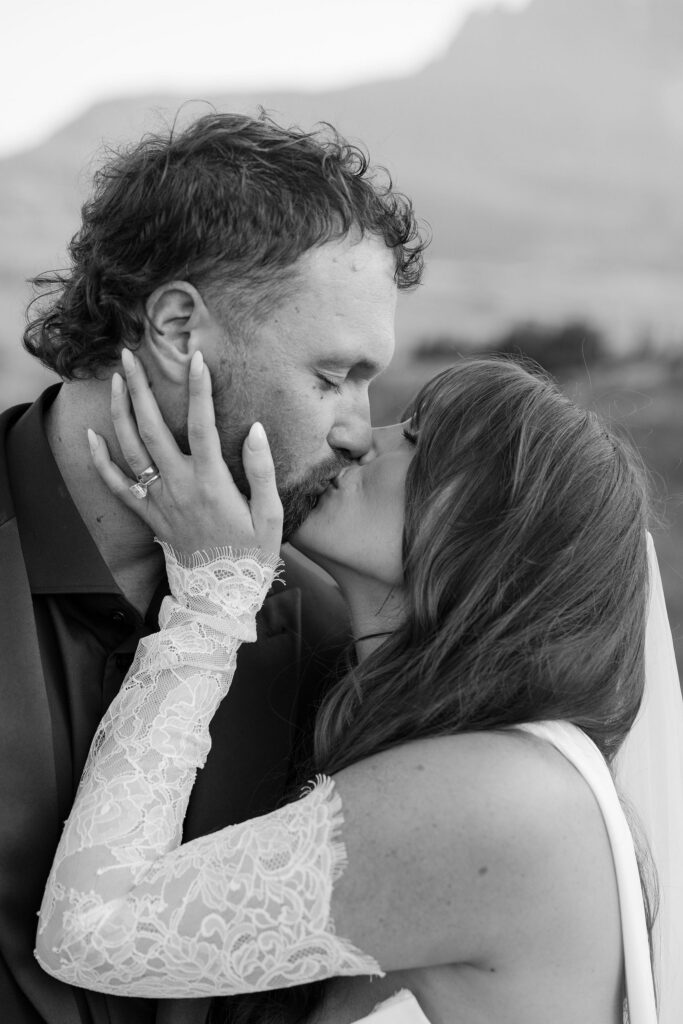 Black and white close-up of bride and groom kissing during their Glacier National Park elopement