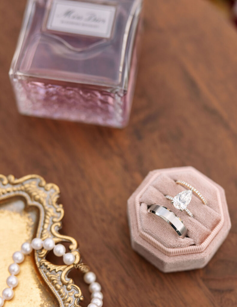 Close-up of diamond engagement ring and wedding band in a ring box during wedding detail photos
