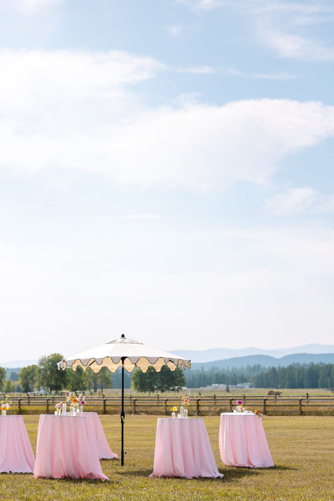 Outdoor wedding reception setup with mountain views and open landscapes in Whitefish Montana